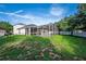 Spacious backyard with a screened-in patio, great for enjoying the outdoors bug free! at 33316 Irongate Dr, Leesburg, FL 34748