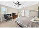 This bedroom provides a desk area, natural light, a ceiling fan and ensuite bath access at 33316 Irongate Dr, Leesburg, FL 34748