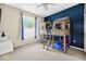 Bedroom features unique bunk beds, neutral carpet, and large window for natural light at 33316 Irongate Dr, Leesburg, FL 34748