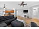 Open concept living room features a fireplace, ceiling fan, and access to the kitchen at 33316 Irongate Dr, Leesburg, FL 34748