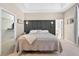 This well-lit main bedroom features a tray ceiling, sconces, and ensuite bath access at 33316 Irongate Dr, Leesburg, FL 34748