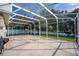 View of the screened patio with an outdoor view of the fence, trees and neighborhood at 33316 Irongate Dr, Leesburg, FL 34748