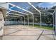 View of the screened patio with an outdoor view of the fence, trees and neighborhood at 33316 Irongate Dr, Leesburg, FL 34748