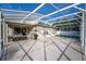 Wide angle view of the screened patio, featuring ample space, outdoor furniture, and a grill at 33316 Irongate Dr, Leesburg, FL 34748