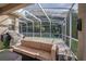 Covered patio featuring cozy outdoor seating, a modern grill, and scenic backyard views at 33316 Irongate Dr, Leesburg, FL 34748