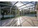 Backyard patio offering views of a lush lawn, mature trees, and enclosed privacy fence at 33316 Irongate Dr, Leesburg, FL 34748