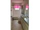 Cozy bathroom featuring a shower-tub combo, vanity, and tiled floor at 35219 Haines Creek Rd, Leesburg, FL 34788