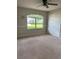 Bright bedroom with neutral carpet, large window, and ample closet space at 35219 Haines Creek Rd, Leesburg, FL 34788