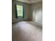 Inviting bedroom with neutral carpet and a large window, offering natural light at 35219 Haines Creek Rd, Leesburg, FL 34788