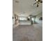Open living room connected to the kitchen, featuring carpet floors and neutral walls at 35219 Haines Creek Rd, Leesburg, FL 34788
