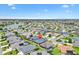 Beautiful aerial shot of the home nestled in a serene neighborhood with lake views and lush greenery at 3566 Gentle Ter, The Villages, FL 32163