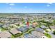 A captivating aerial view of the home showcasing the pool and the tranquil lake views in the distance at 3566 Gentle Ter, The Villages, FL 32163