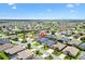 Expansive aerial view of the home in a lovely community with well-manicured lawns and lush landscaping at 3566 Gentle Ter, The Villages, FL 32163