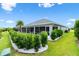 Well maintained lawn with a view of the screened in lanai and white rock landscaping at 3566 Gentle Ter, The Villages, FL 32163