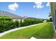 Lush backyard featuring manicured landscaping, a well-kept lawn, and neighborhood views at 3566 Gentle Ter, The Villages, FL 32163