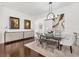 Elegant dining room featuring a modern glass table, stylish chairs, and unique decorative accents at 3566 Gentle Ter, The Villages, FL 32163