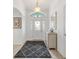 Bright foyer featuring elegant decor, decorative mirror, and view of the entry door at 3566 Gentle Ter, The Villages, FL 32163