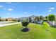 Well-manicured front yard featuring lush grass, decorative plants, and a charming single-story home at 3566 Gentle Ter, The Villages, FL 32163