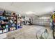 Spacious two-car garage with ample storage shelves and an automatic door system for secure parking at 3566 Gentle Ter, The Villages, FL 32163