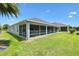 Exterior view of the enclosed patio, providing a seamless transition from indoor living to outdoor relaxation at 3566 Gentle Ter, The Villages, FL 32163