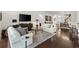 Comfortable living room featuring hardwood floors, neutral tones, and a stylish rug at 3566 Gentle Ter, The Villages, FL 32163