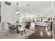 Open-concept living space with dining area and modern kitchen offering seamless flow and ample natural light at 3566 Gentle Ter, The Villages, FL 32163