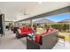 Spacious screened lanai featuring comfortable seating and an open view of the backyard and blue skies at 3566 Gentle Ter, The Villages, FL 32163