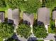 Overhead aerial view of the neighborhood homes, mature trees, and street at 3586 Eversholt St, Clermont, FL 34711