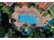 Aerial view of a community pool, with poolside seating and surrounded by palm trees at 3586 Eversholt St, Clermont, FL 34711