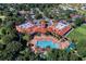 Aerial view of a community showcasing a pool, clubhouse, meticulously landscaped gardens, and various amenities at 3586 Eversholt St, Clermont, FL 34711