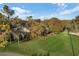 Aerial view of golf course frontage, with green lawns and mature trees surrounding the community, on a clear day at 3586 Eversholt St, Clermont, FL 34711