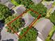 Aerial view of a home surrounded by mature trees and a red line around the property at 3586 Eversholt St, Clermont, FL 34711
