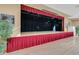 Open auditorium with a hardwood stage, complete with dark stage curtains, bright lighting, and views from every angle at 3586 Eversholt St, Clermont, FL 34711