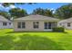 Home's backyard showcasing its well-maintained lawn and the property's overall exterior at 3586 Eversholt St, Clermont, FL 34711