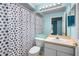Bathroom featuring a vanity, mirror, and shower with a blue-and-white shower curtain at 3586 Eversholt St, Clermont, FL 34711