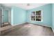 Bedroom featuring light-blue walls, wood-look floors, ceiling fan, and window at 3586 Eversholt St, Clermont, FL 34711