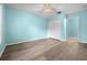 Spacious bedroom featuring light-blue walls, wood-look floors, and a ceiling fan at 3586 Eversholt St, Clermont, FL 34711