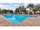 Large community pool with marked swim lanes and poolside seating, with lots of palm trees at 3586 Eversholt St, Clermont, FL 34711