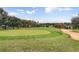 Lush golf course featuring verdant greens, gently rolling fairways, and clear blue skies on a sunny day at 3586 Eversholt St, Clermont, FL 34711