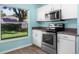 Clean kitchen featuring stainless steel appliances, granite counters, and bright window view at 3586 Eversholt St, Clermont, FL 34711