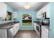 Efficient kitchen with stainless steel appliances, granite counters, and ample natural light from the window at 3586 Eversholt St, Clermont, FL 34711