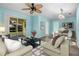 Bright living room featuring modern furnishings, sleek flooring, and sliding glass doors to the lanai at 3586 Eversholt St, Clermont, FL 34711