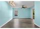 Open-concept living room featuring sleek floors, natural light, and smooth flow to outdoor area at 3586 Eversholt St, Clermont, FL 34711