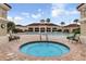 Community pool and hot tub surrounded by lounge chairs and manicured landscaping, perfect for relaxation at 3586 Eversholt St, Clermont, FL 34711