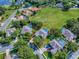 Aerial view of the neighborhood and the home, featuring a screened pool and landscaping, inside property lines at 359 Blue Branch St, Eustis, FL 32736