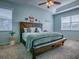Inviting bedroom features a stylish wooden bed frame, a comfortable bench, and ample natural light at 359 Blue Branch St, Eustis, FL 32736