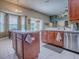 Bright kitchen features a center island, stainless steel appliances, and a dining area with natural light at 359 Blue Branch St, Eustis, FL 32736