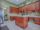 Well-equipped kitchen featuring ample wood cabinetry, a convenient center island, and neutral countertops at 359 Blue Branch St, Eustis, FL 32736