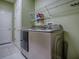 Laundry room with modern appliances and tiled floor, offering convenience at 359 Blue Branch St, Eustis, FL 32736