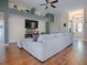 Open-concept living room with hardwood floors, custom shelving, and natural light from the front door at 359 Blue Branch St, Eustis, FL 32736